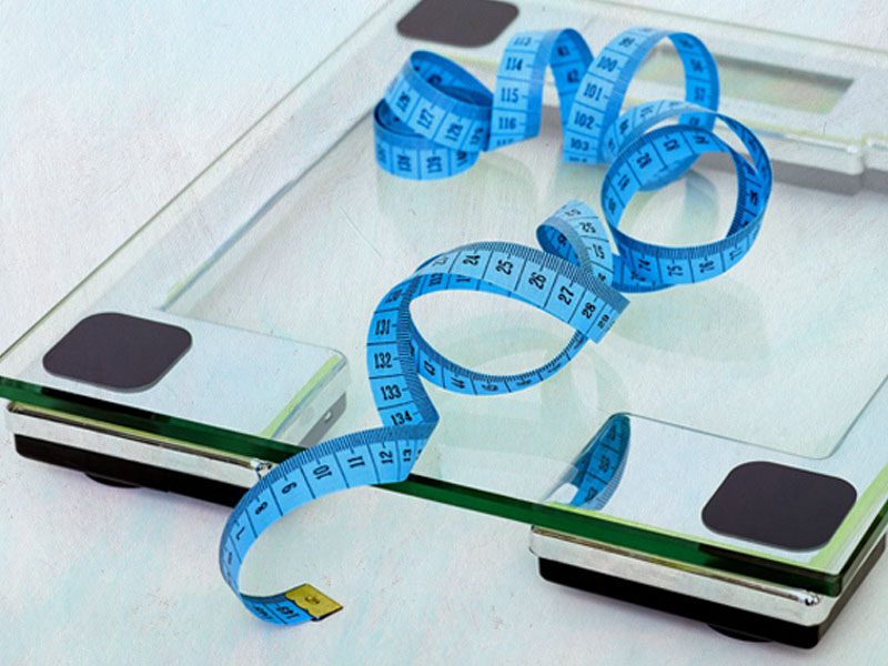 Weight management scales with a curly tape measure